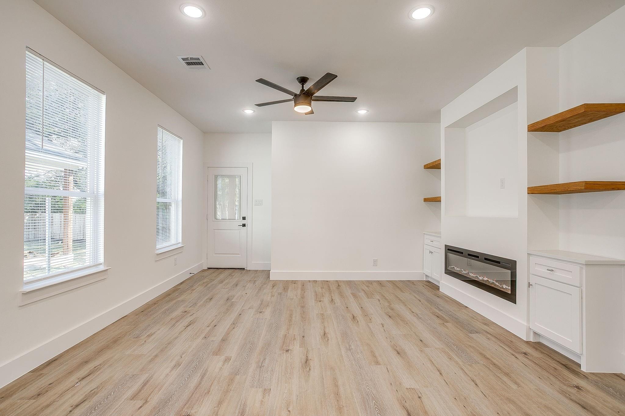 Dunbar Residence — living room with fireplace and floating shelves