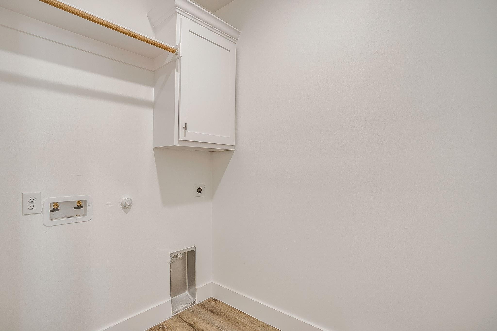 Dunbar Residence — laundry room with upper cabinetry