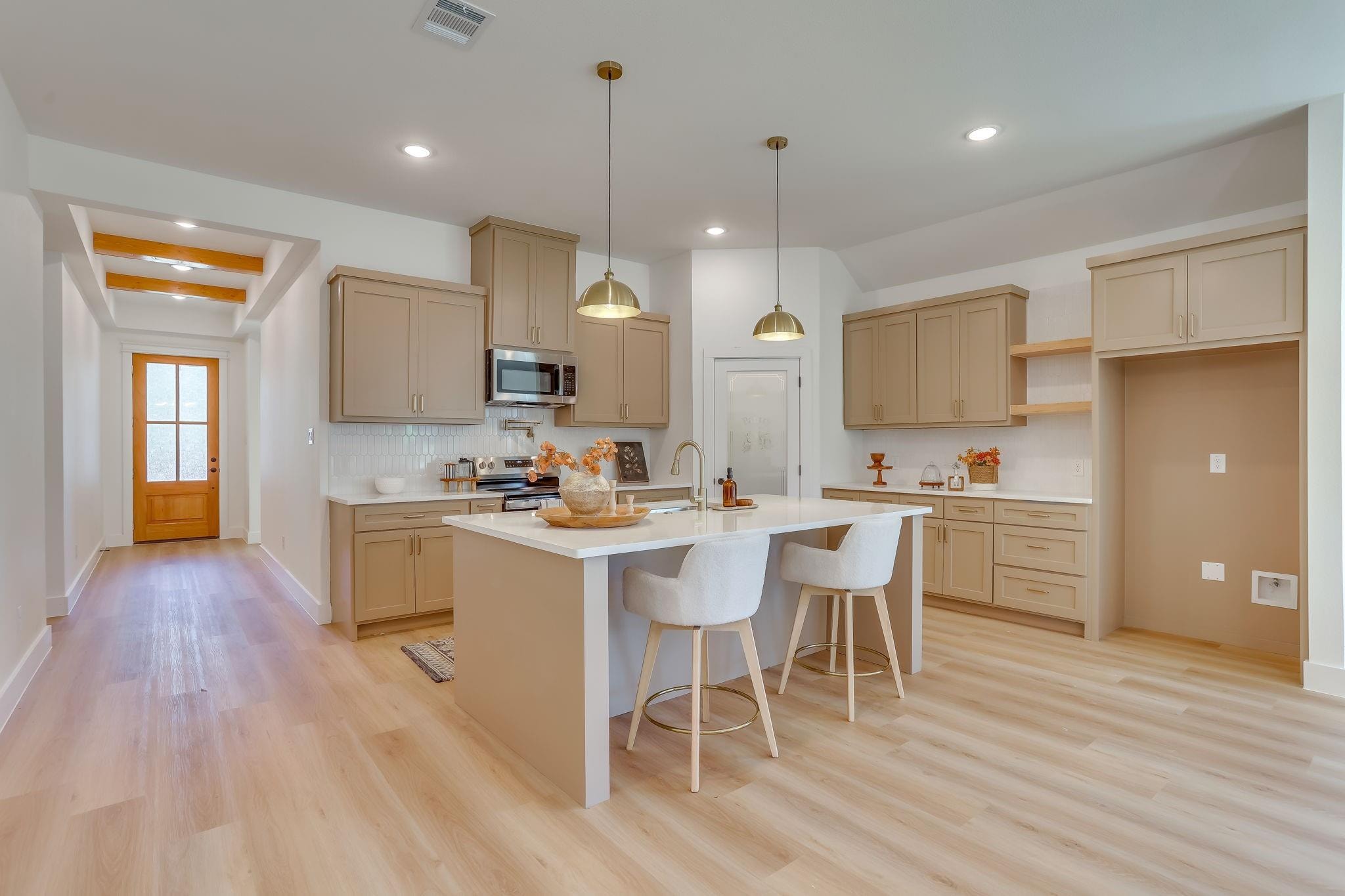 Humbert Residence — kitchen with island and brass pendants